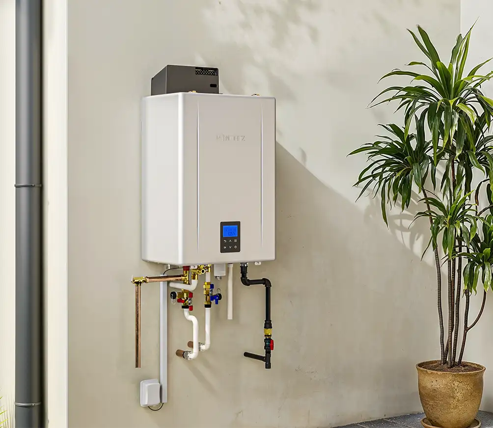 Wall-mounted tankless water heater replacement with clean visible piping